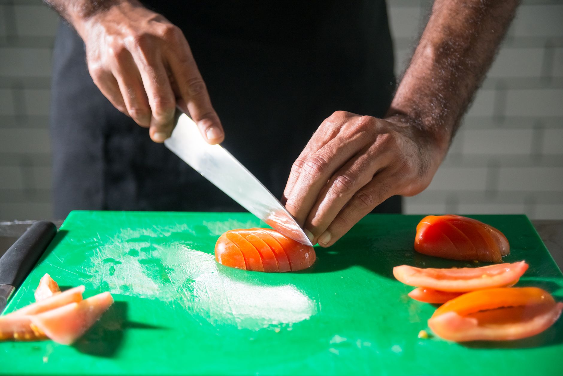 Hands on a board — close crop of knife work
